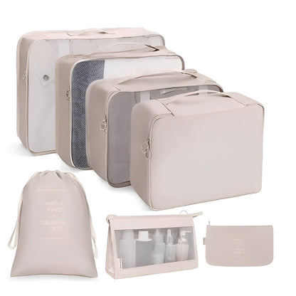 Set of beige travel packing cubes and bags on a white background
