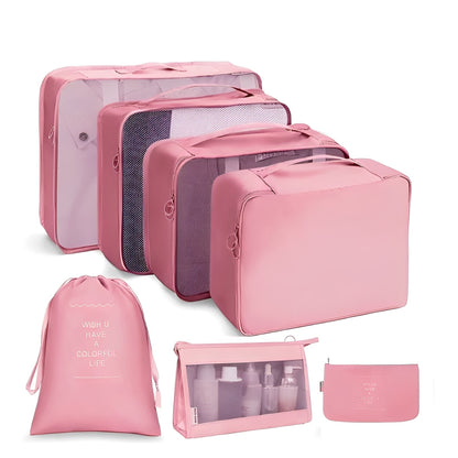 Set of pink travel packing cubes and bags on a white background