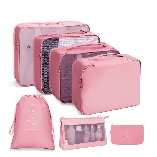 Set of pink travel packing cubes and bags on a white background