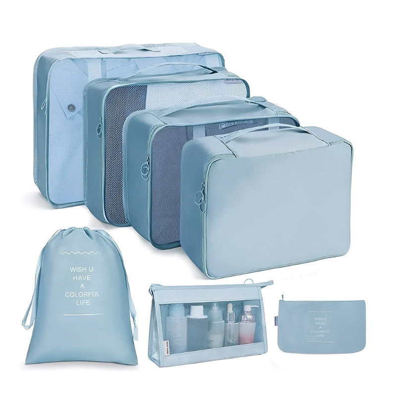 Set of light blue travel packing cubes and bags on a white background