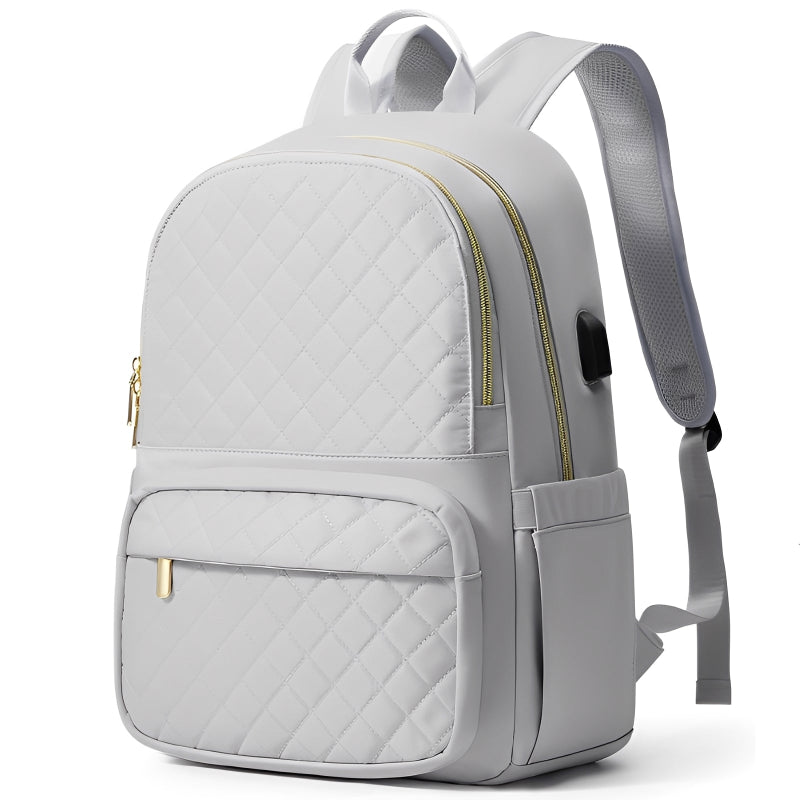 Gray quilted backpack with gold zipper on a white background