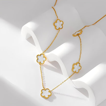 Gold necklace with clover-shaped pendants on a white background