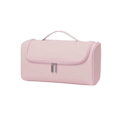Pink toiletry bag with a handle on a white background