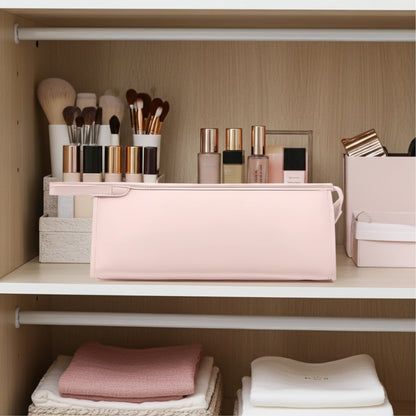 Makeup brushes and products with a hair dryer case on a shelf in a well-organized closet.