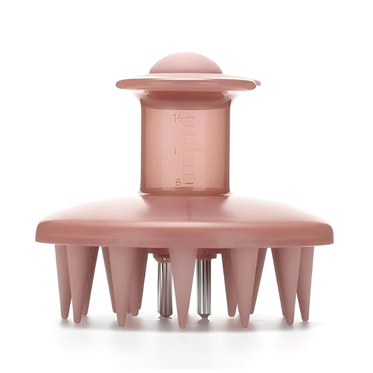 Pink scalp massager with measurement markings on a white background