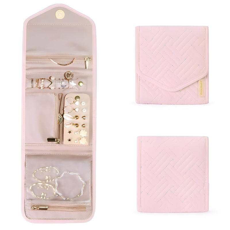 Pink jewelry travel case with jewelry inside on a white background