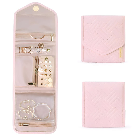 Pink jewelry travel case with jewelry inside on a white background