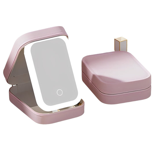 Pink makeup mirror with a compact case on a white background
