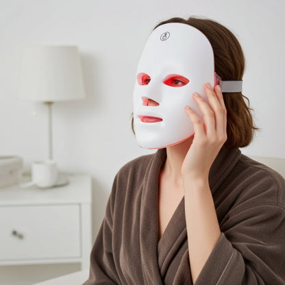 Person wearing a white LED face mask in a home setting