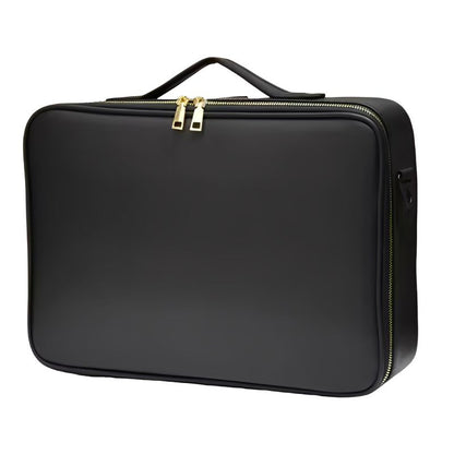 Black makeup case with gold zipper on a white background