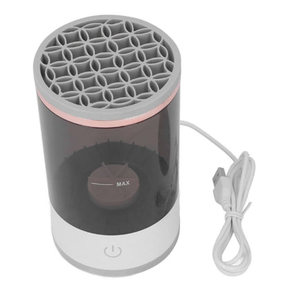 Portable makeup brush cleaner with gray top and black body on a white background